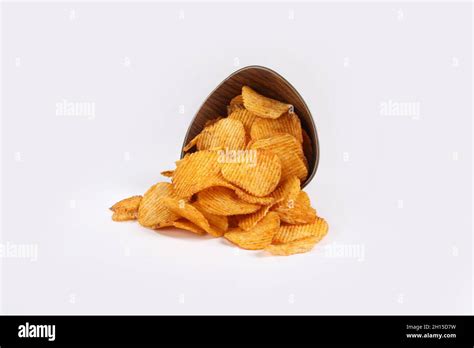 Potato Chips Falling Into Glass Bowl Isolated On White Background With