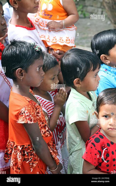 Group Of Young Bengali Catholics Pray Before A Statue Of The Blessed