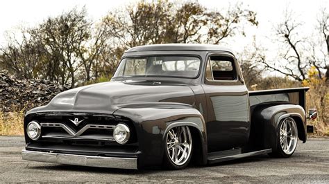 An Old Black Pickup Truck Parked In A Parking Lot