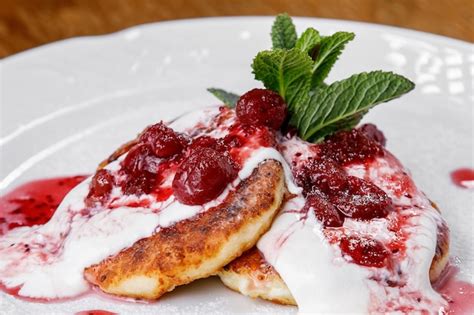 Premium Photo Cheese Pancake Cheesecakes With Sour Cream Jam And Mint