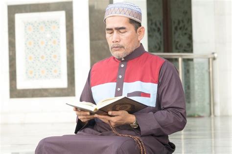 Premium Photo Mature Man Reading Koran While Sitting At Mosque