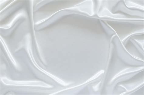 Smooth Elegant Wavy White Satin Cloth Texture Background With Space For