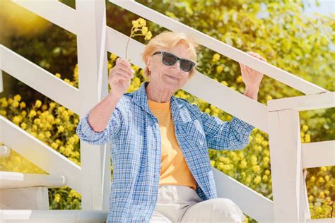 Mature Attractive Woman Traveler Sitting Alone On The Terrace Of Beach