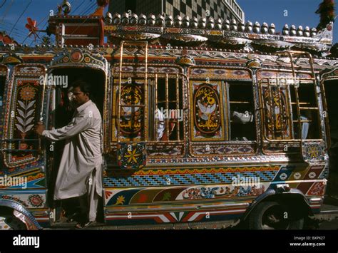 A Multi Colored Bus Moves On The Streets Of Downtown Karachi Pakistan