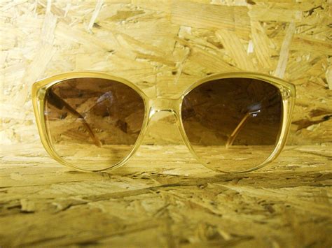 Download Trendy Saint Laurent 70s Yellow Sunglasses Wallpaper