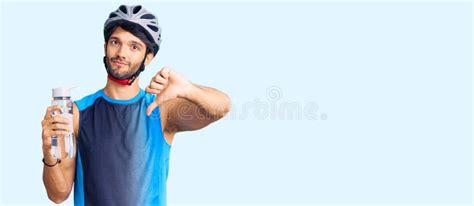 Handsome Hispanic Man Wearing Bike Helmet And Holding Water Bottle With