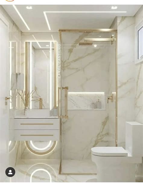 A White Bathroom With Marble Walls And Flooring