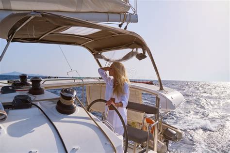 Beautiful Woman Standing On Yacht Captain S Bridge At Sunny Summer Day