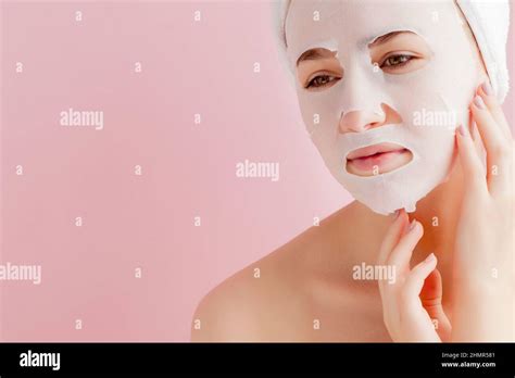 Beautiful Young Woman Is Applying A Cosmetic Tissue Mask On A Face On A