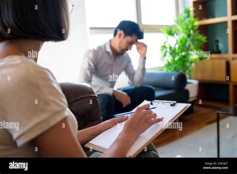 Psychologist Taking Notes During Therapy Session Stock Photo Alamy