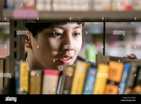 Face Of School Boy Looking For A Book In Library Stock Photo Alamy