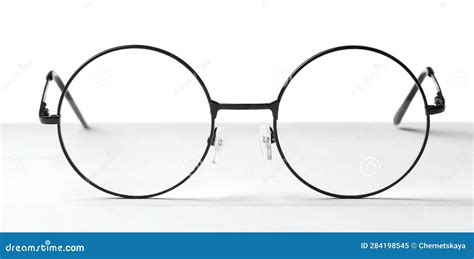 Round Glasses with Metal Frame on Table Against White Stock Image ...