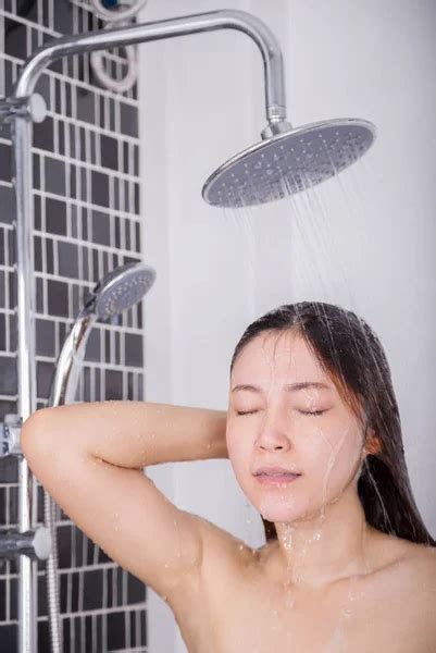 Woman Is Washing Her Hair And Face By Rain Shower Rear View — Stock