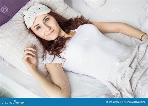 An Attractive Young Brunette Girl Woman Wakes Up In Her Bed In A Sleep