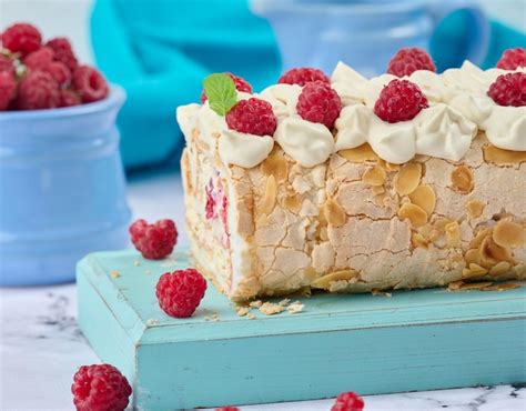 Premium Photo Baked Meringue Roll With Cream And Fresh Red Raspberry