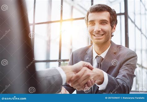 Portrait Of Confident Mature Specialist Sitting At The Table And