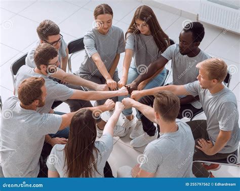Group Of Young Like Minded People Sitting In A Circle Stock Photo
