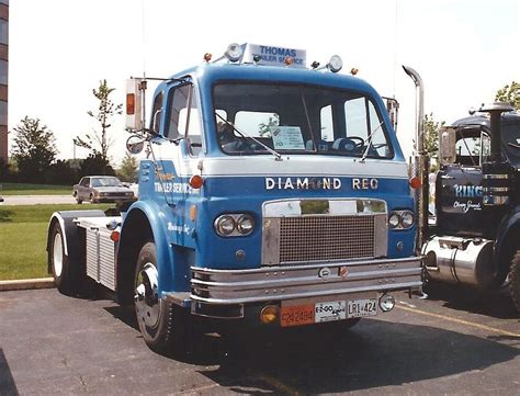 A Large Blue Truck Parked In A Parking Lot