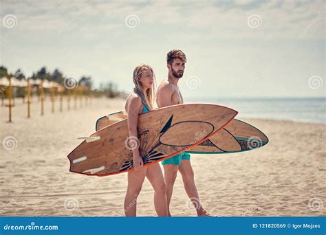 Couple Of Surfers Walking On Coast In Indonesia Royalty Free Stock