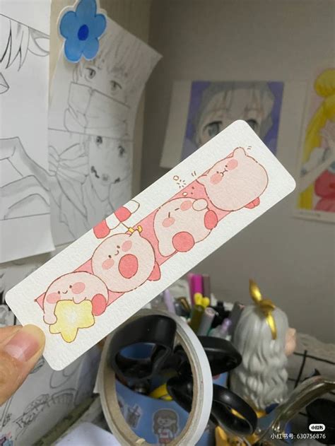 A Person Holding Up A Sticker With Three Pigs On It In Front Of Some