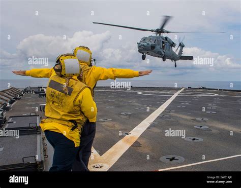 Airmen Signal To An Mh S Sea Hawk Helicopter As It Lands On The