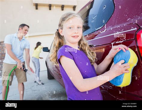 Caucasian Father And Children Washing Car In Driveway Stock Photo Alamy