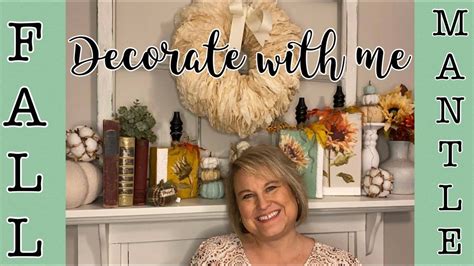 A Woman Sitting In Front Of A Mantle With Decorations On It And The