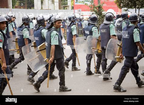 Police wearing blue uniform marching with stick on road to control the ...