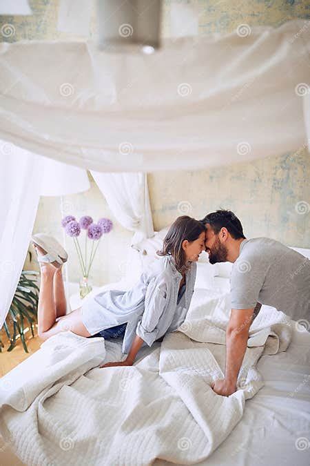 Couple Kissing In The Morning While Making The Bed Bedroom Morning Togetherness Romance