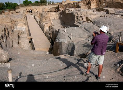 A Tourist Takes A Photograph Of The Unfinished Obelisk At The Ancient