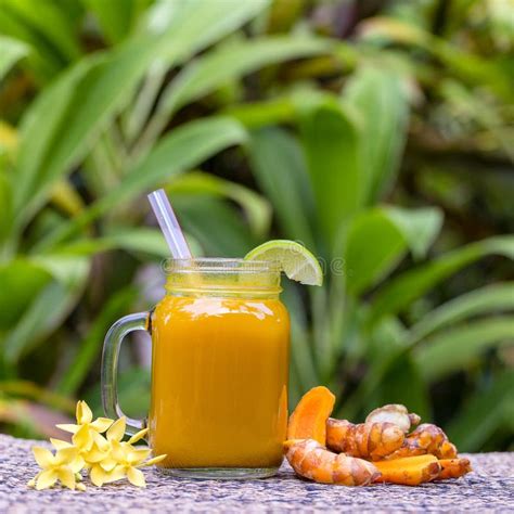 Energy Tonic Drink With Turmeric Ginger Lemon And Honey In Glass Mug Nature Background Close