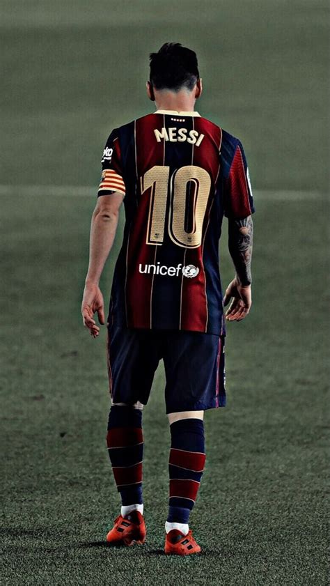 A Man Standing On Top Of A Soccer Field Wearing A Uniform That Says Messi