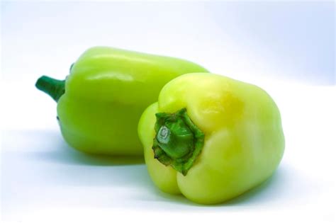 Premium Photo Two Green Peppers On A White Background