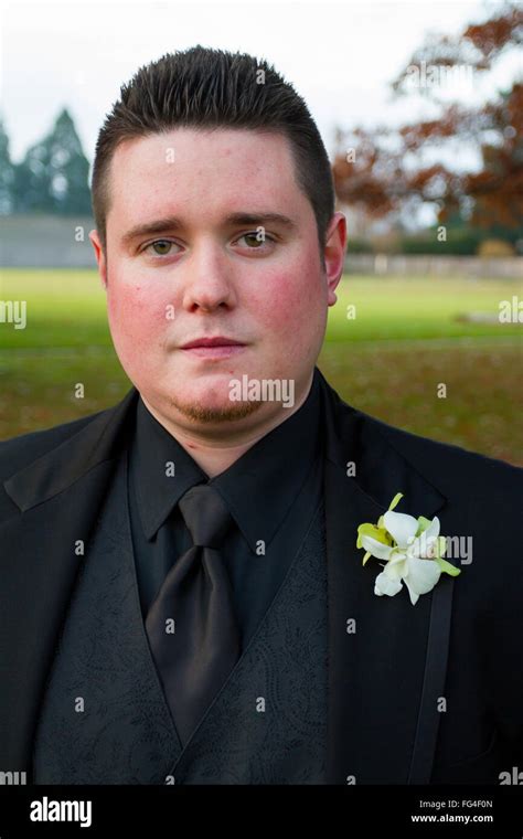 Groom Posing For A Portrait Outdoors On His Wedding Day In Oregon