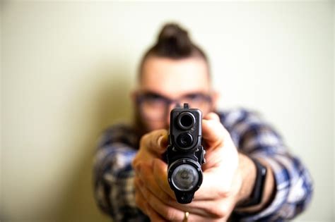 Premium Photo Midsection Of Man Holding Gun