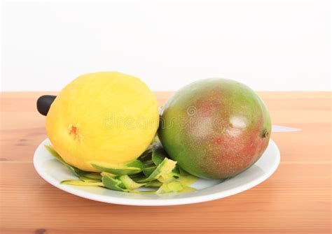 Peeled And Unpeeled Mangoes On White Plate Stock Photo Image Of