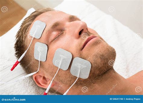 Man Closing Eyes With Electrodes On Face Stock Photo Image Of Clinic