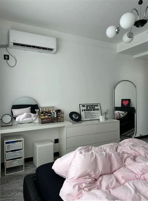 A Bedroom With A Bed Dresser And Air Conditioner On The Wall Next To It