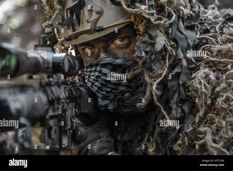 sniper wearing ghillie suit Stock Photo - Alamy