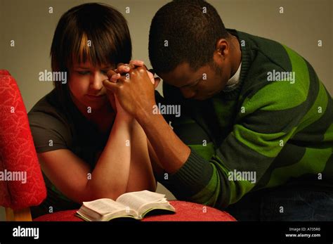 A couple praying together Stock Photo - Alamy