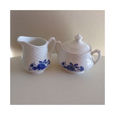 Two White Vases With Blue Flowers On Them