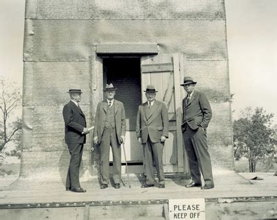 "Group standing in front of Wright Memorial under construction"