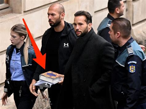 Photos Show A Handcuffed Andrew Tate Carrying The Quran To His Court