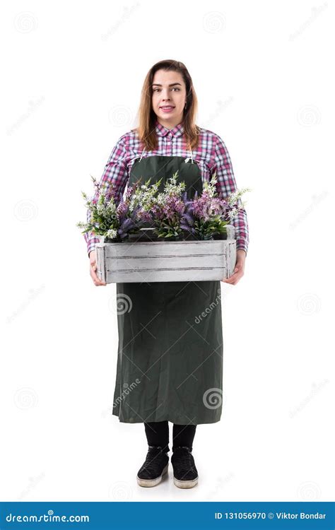 Woman Professional Gardener Or Florist In Apron Holding Flowers In A