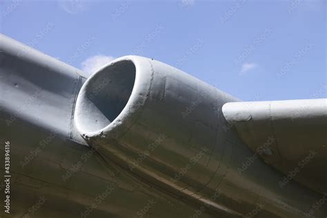 Turbojet engine of a flying Soviet supersonic military aircraft close-up against a clear blue ...