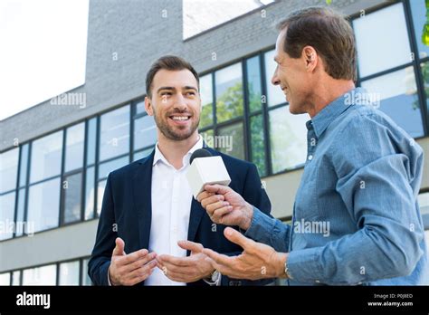Smiling Mature Journalist Takig Interview With Successful Businessman
