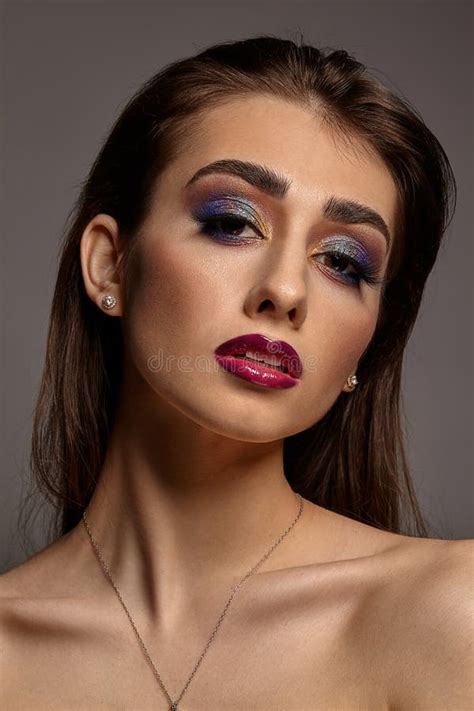 Brunette Naked Girl In Jewelry Posing On Gray Studio Background Luxury Makeup Colorful