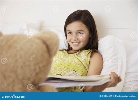 Girl Reading Story Book To Her Teddy Bear Stock Image Image Of