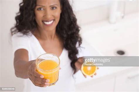 Black Person Drinking Orange Juice Photos And Premium High Res Pictures