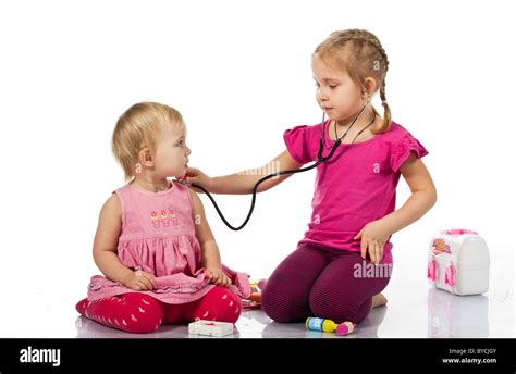 Children Playing Doctor With A Doll Isolated On White Stock Photo Alamy